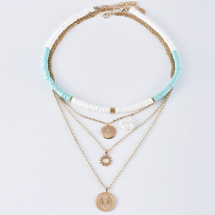 Simone™ necklace set by Emma & Rose Cape Town featuring layered gold-tone chains with pendant charms.