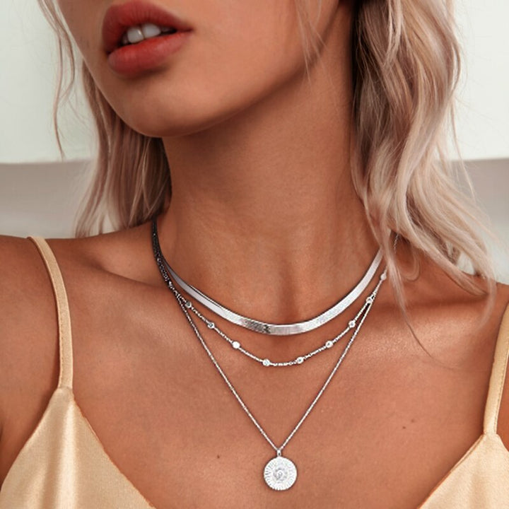 Emma & Rose Cape Town Triple Radiant Necklace featuring layered gold chains and sparkling pendant on a white background.