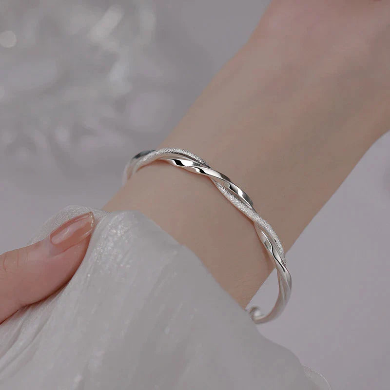 Ximena™ braided silver bracelet by Emma & Rose Cape Town, featuring intricate silver woven design on a sleek bracelet.