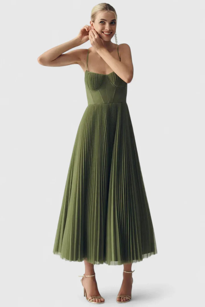 Green Hylyana™ elegant dress by Emma & Rose Cape Town, with flowing fabric and intricate design details.