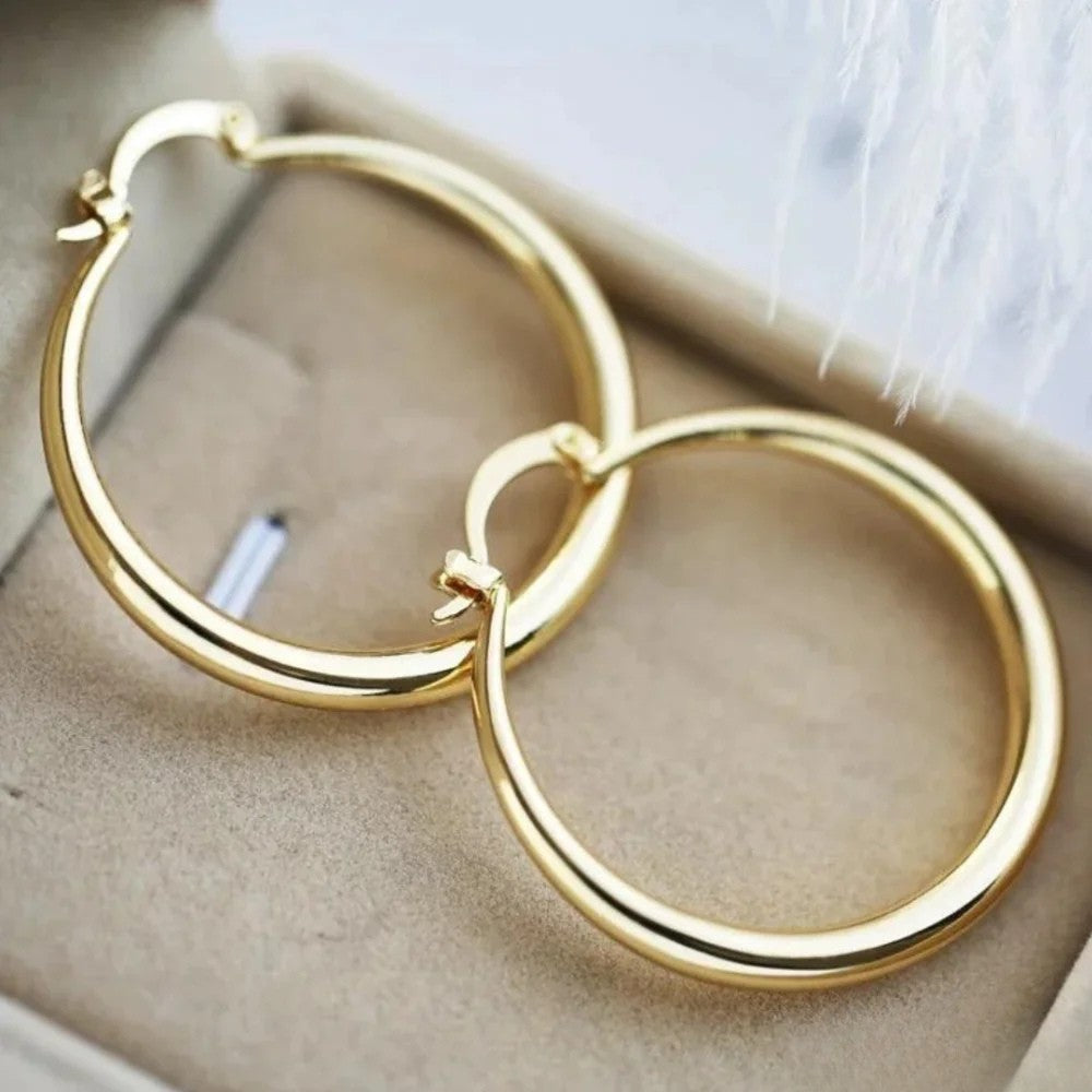 Large Emma & Rose Cape Town golden hoop earrings, shiny metal hoops with a smooth finish, designed for elegant style.