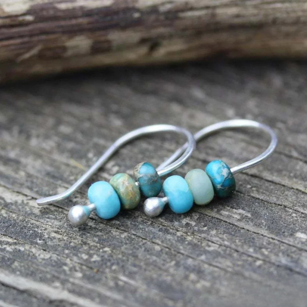 Turquoise and pearl earrings by Emma & Rose Cape Town featuring elegant dangle design with vibrant turquoise stones and white pearls.