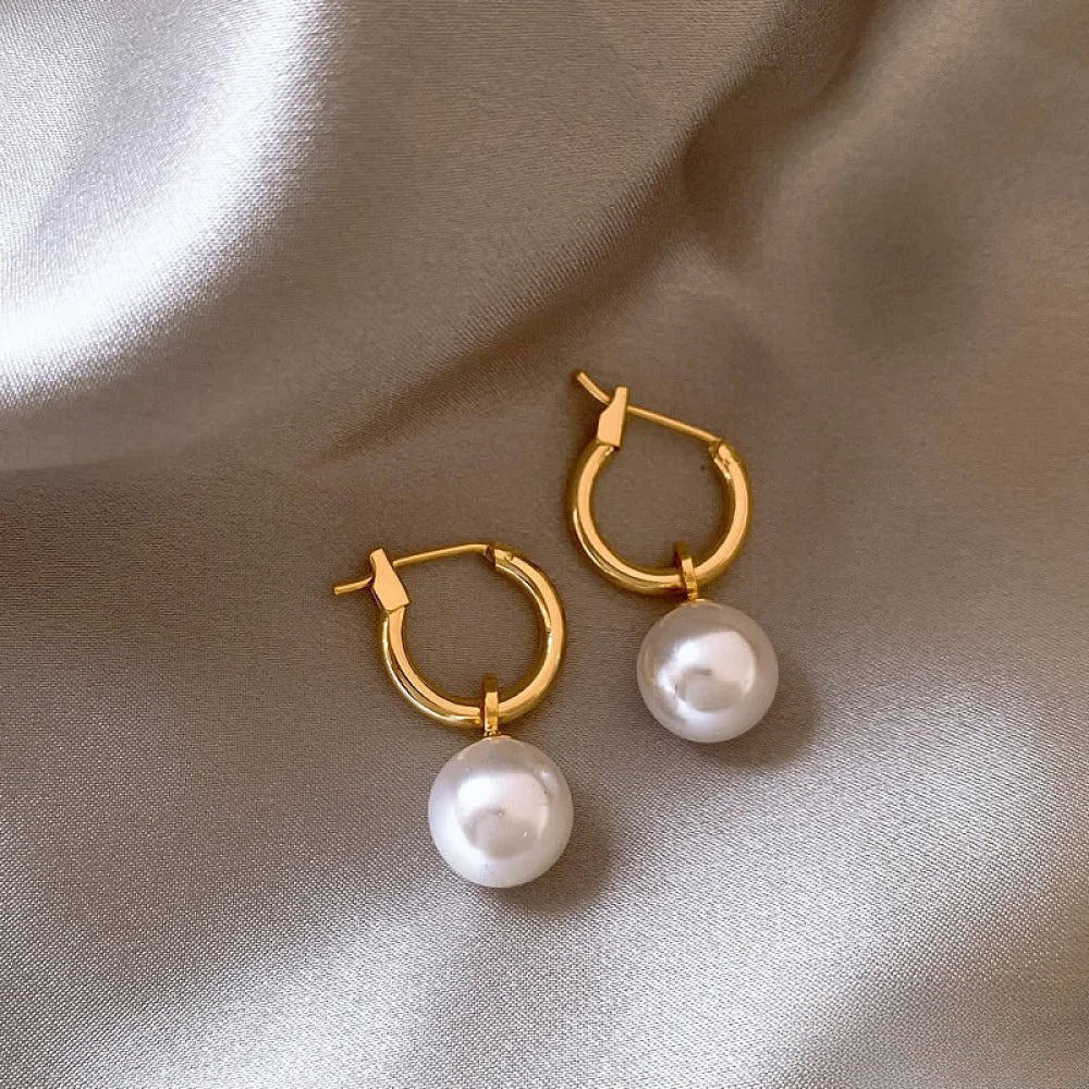 Emma & Rose Cape Town Yolande elegant earrings with golden pearls, showcasing delicate design and shimmering pearl accents.