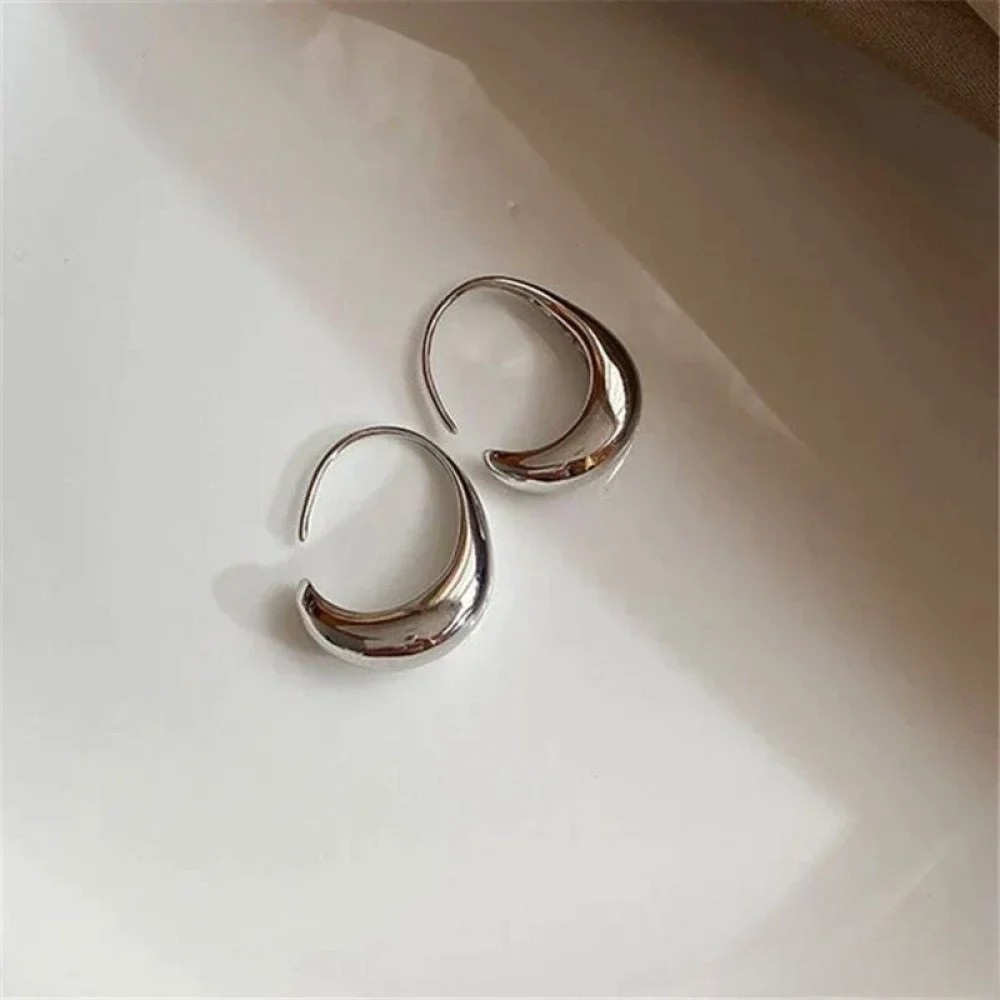 Gold Imke™ Elegant Earrings by Emma & Rose Cape Town, featuring smooth, polished design with intricate details.