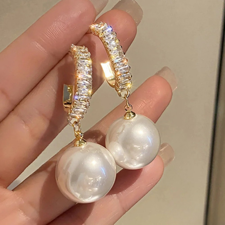 Elegant Gabriëlle™ earrings by Emma & Rose Cape Town featuring white pearls and sparkling zirconia in a sophisticated design.