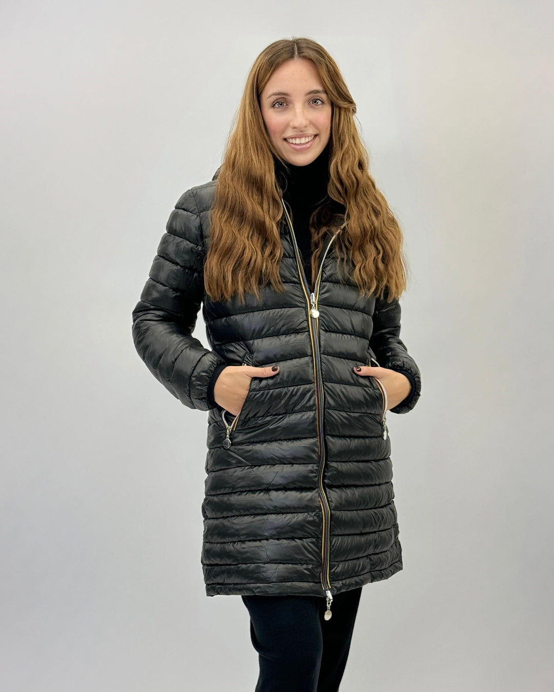 Black Carien™ reversible double-face coat by Emma & Rose Cape Town, shown hanging on a wooden coat rack.