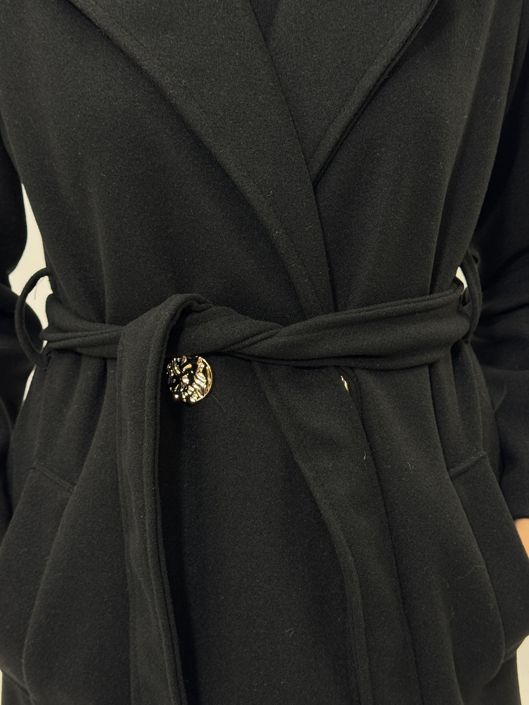 Black Fleur™ long coat by Emma & Rose Cape Town with belt, designed for warmth and stylish winter wear.