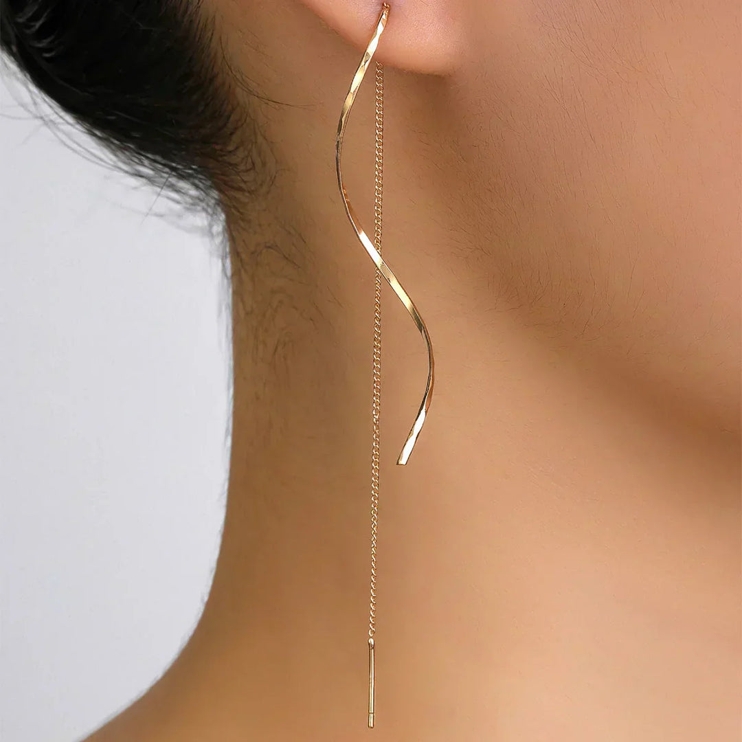 Emma & Rose Cape Town Phaedra™ long gold earrings with wavy design and elegant dangle style.