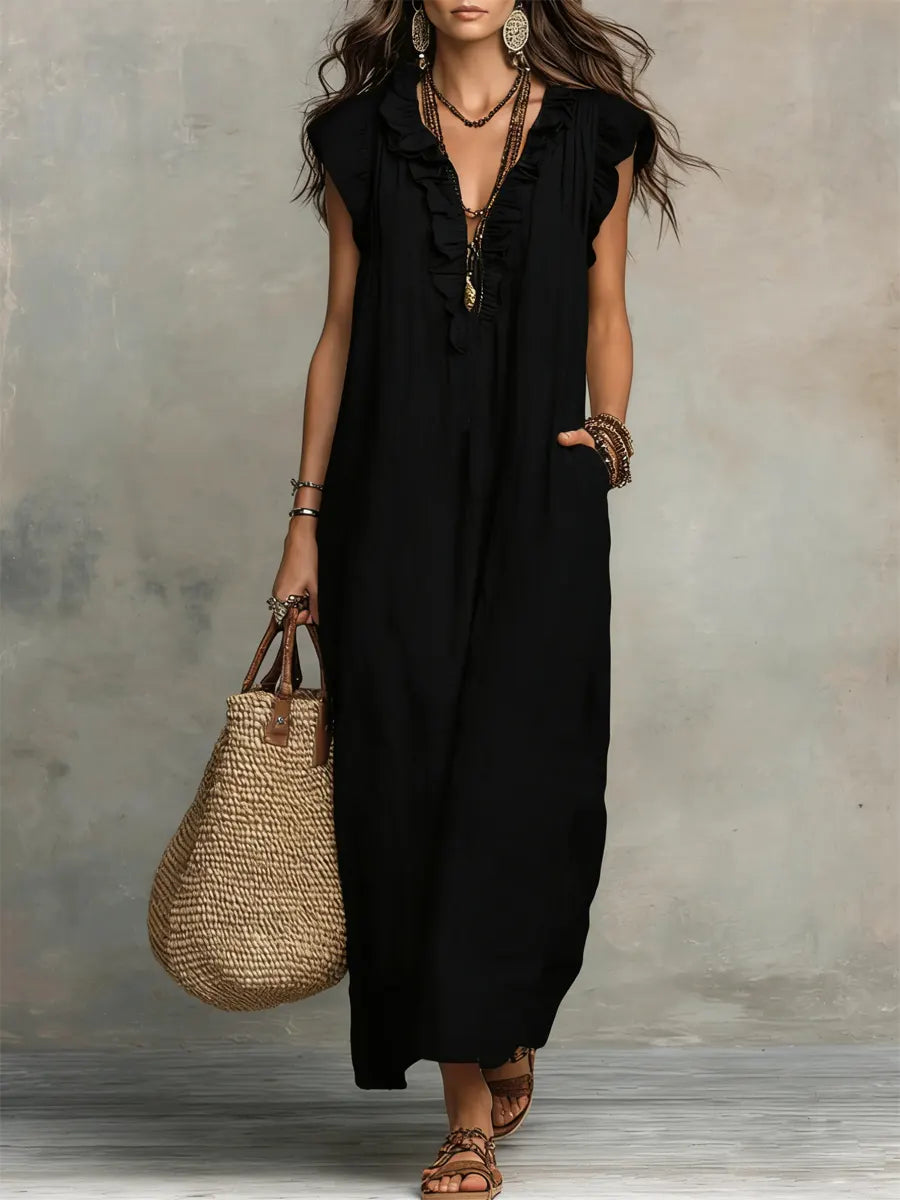 Long Bohemian dress by Emma & Rose Cape Town featuring flowing fabric and intricate floral details in a vibrant design.