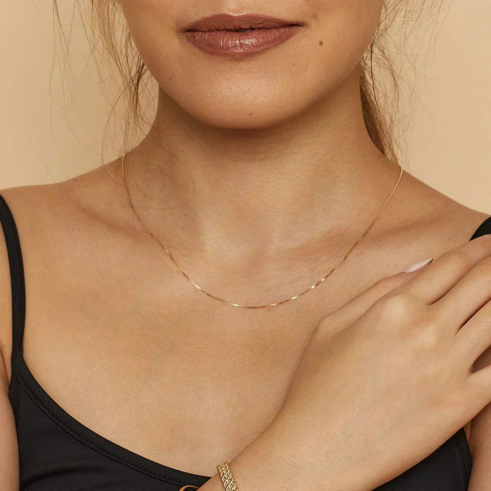 Emma & Rose Cape Town Clarionne™ 18K gold necklace featuring elegant chain design, showcasing luxurious jewelry craftsmanship.