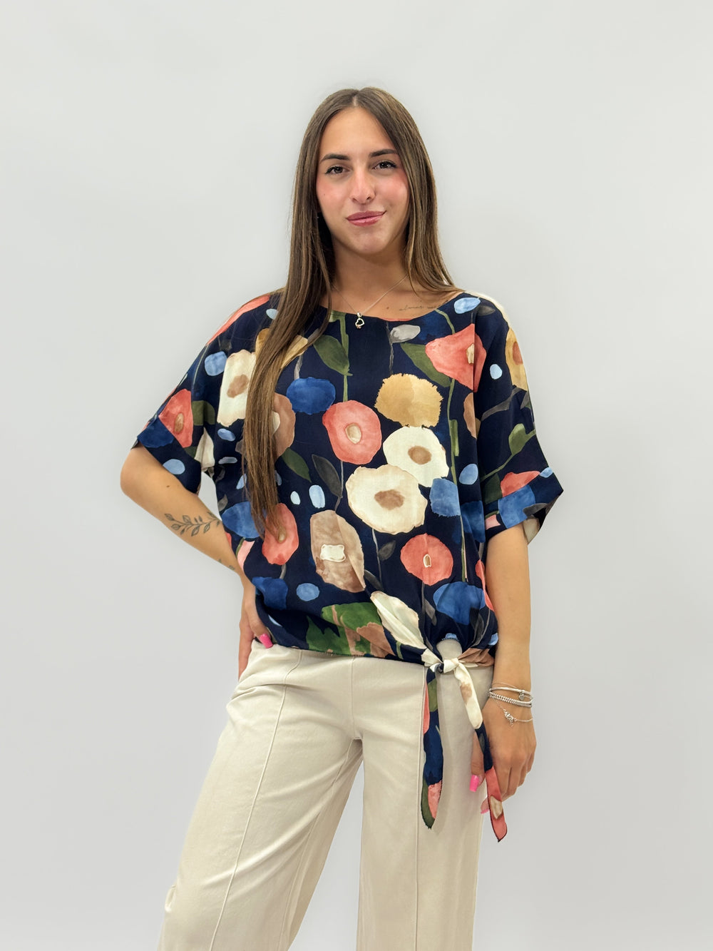 Beige Dominique™ knit top by Emma & Rose Cape Town with a stylish knot detail, showcasing cozy, lightweight maglieria fashion.