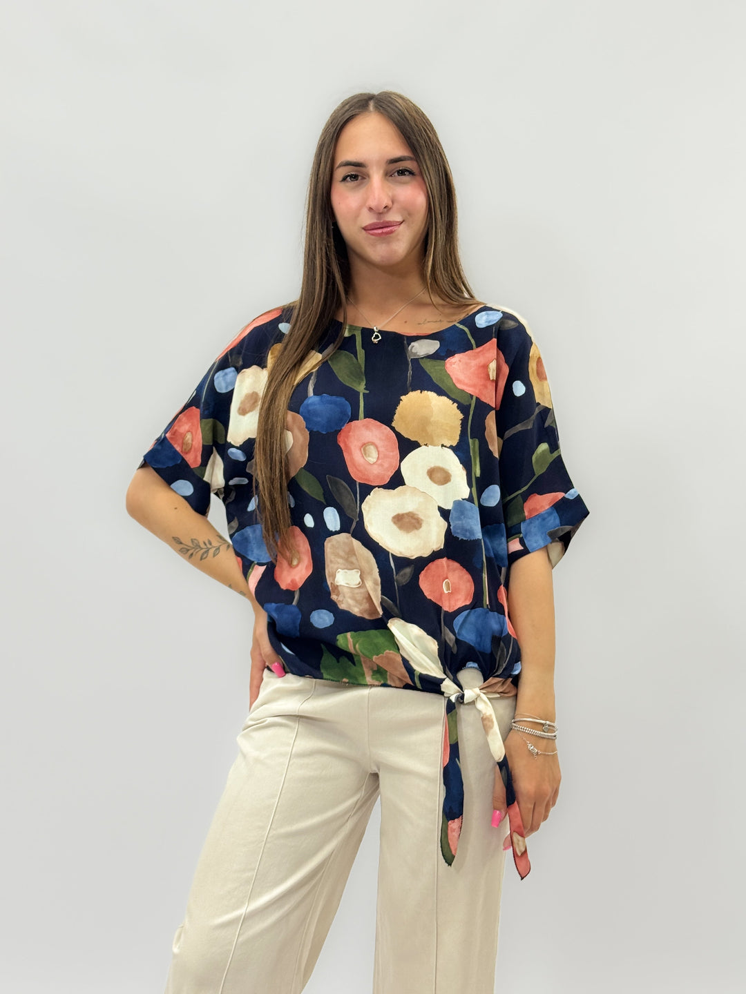 Beige Dominique™ knit top by Emma & Rose Cape Town with a stylish knot detail, showcasing cozy, lightweight maglieria fashion.