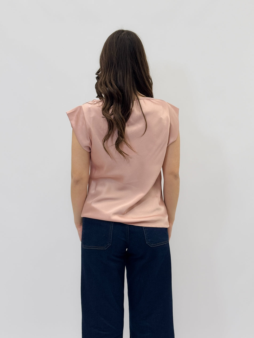 Black Francien™ maglieria top with a stylish neckline from Emma & Rose Cape Town, showcased on a model.