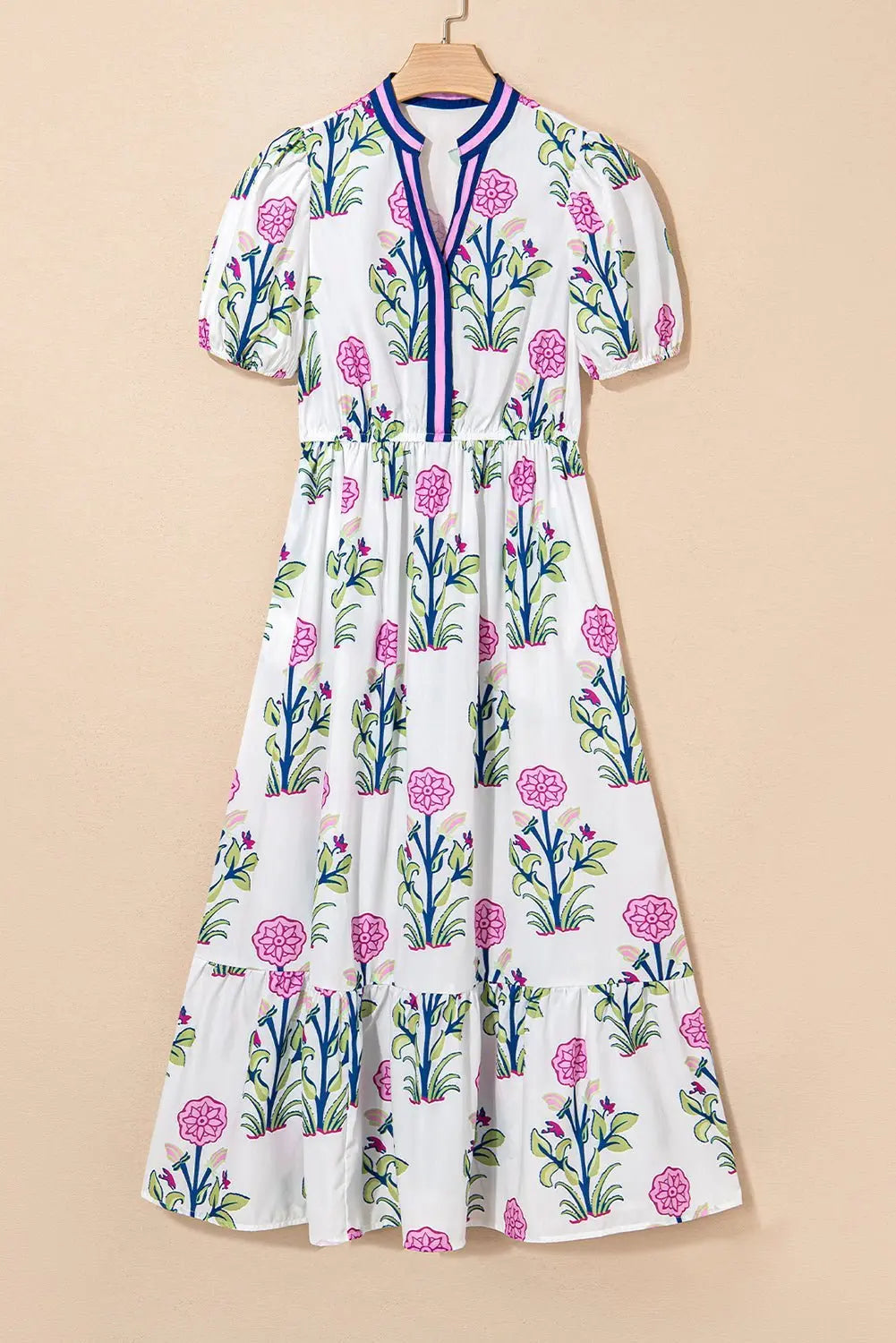 White floral midi dress by Emma & Rose Cape Town featuring ruffle hem and colorful neckline for a stylish look.