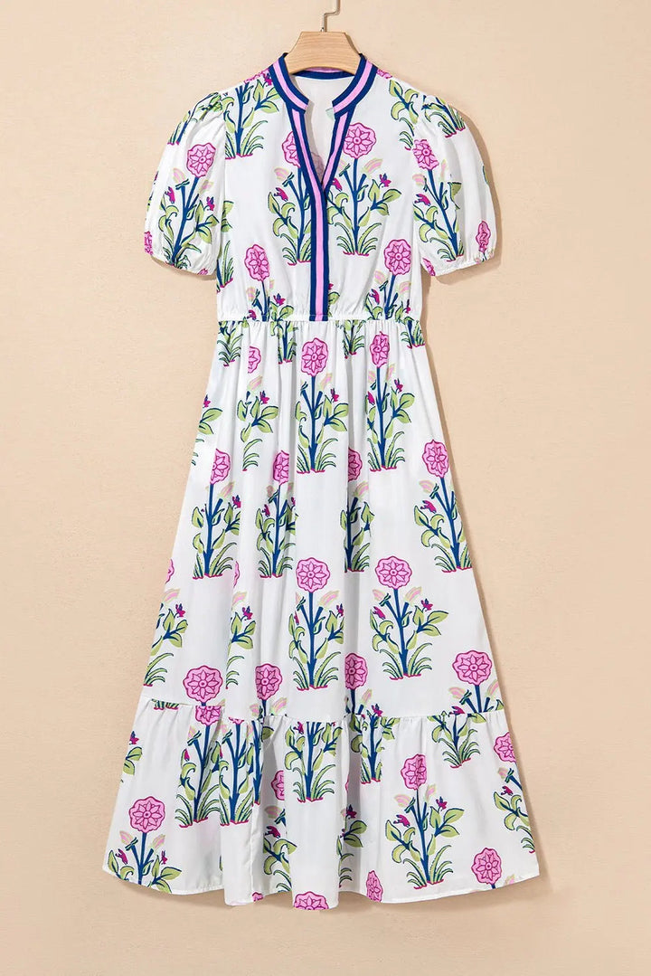 White floral midi dress by Emma & Rose Cape Town featuring ruffle hem and colorful neckline for a stylish look.