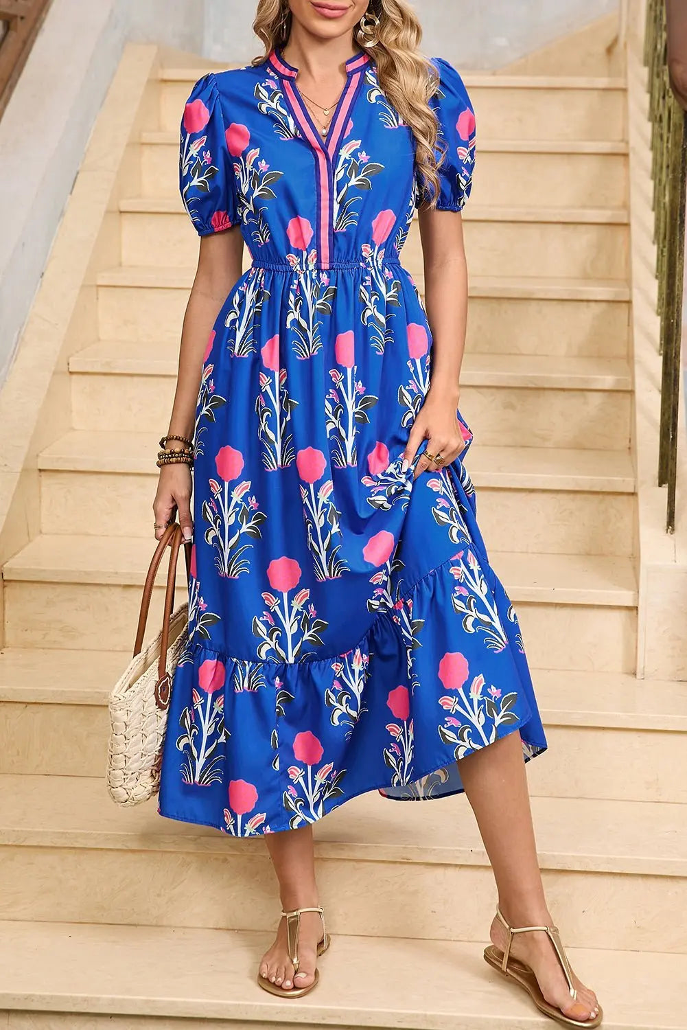 White floral midi dress by Emma & Rose Cape Town featuring ruffle hem and colorful neckline detail.