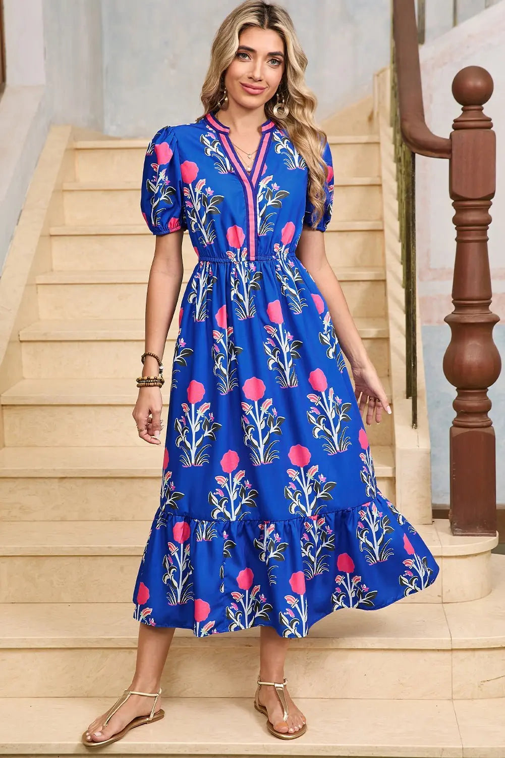 White floral midi dress by Emma & Rose Cape Town with ruffle hem and colorful neckline, perfect for spring occasions.