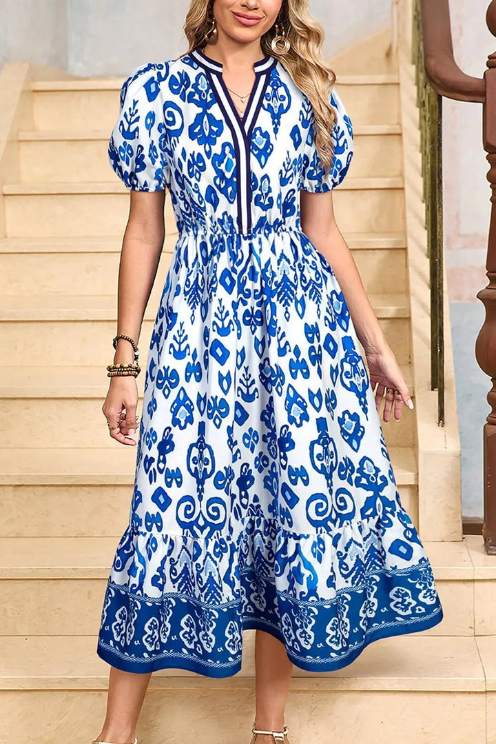White floral midi dress with ruffle hem and colorful neckline by Emma & Rose Cape Town, perfect for casual or dressy occasions.