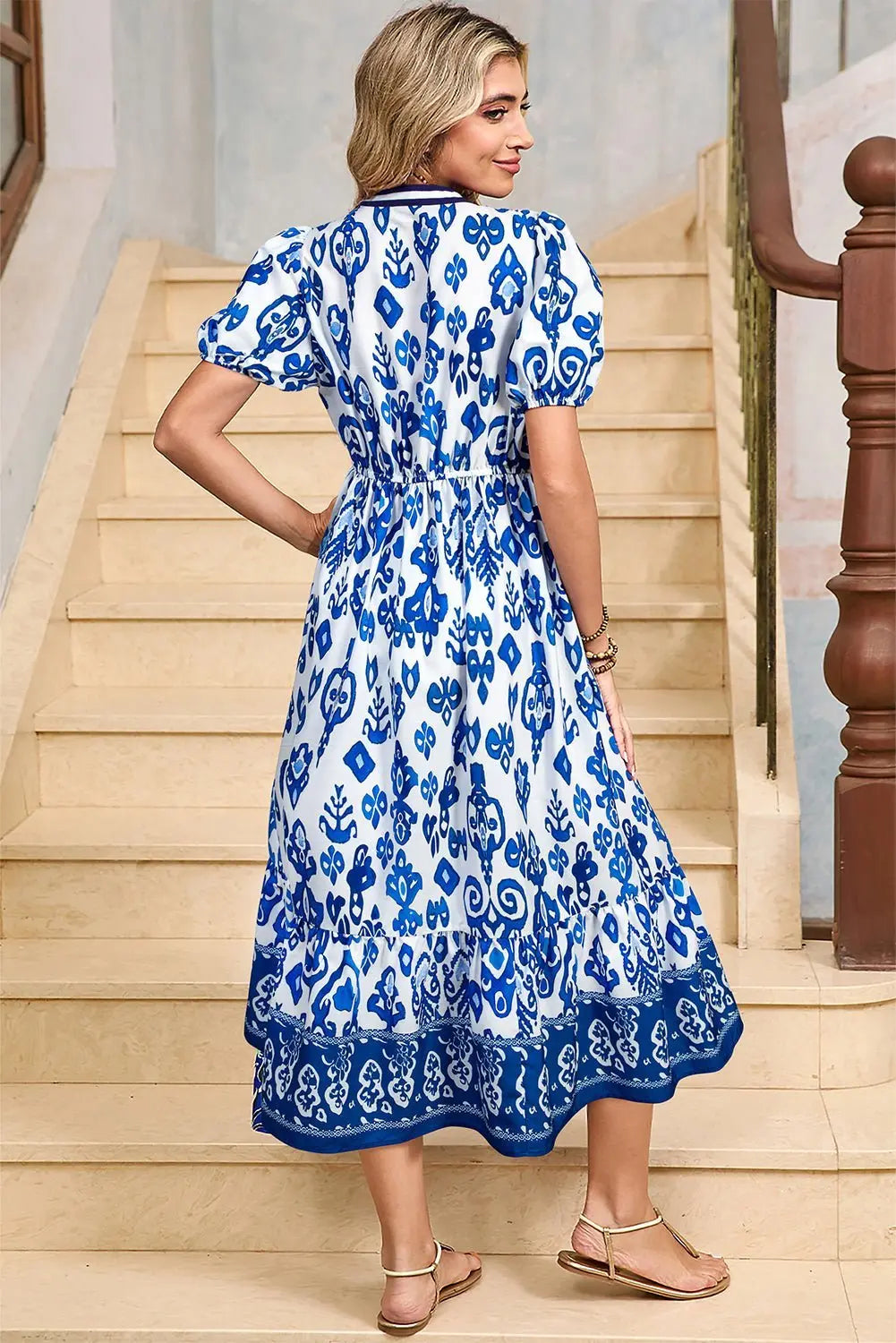 White floral midi dress with ruffle hem and pop of color neckline by Emma & Rose Cape Town, displayed on a hanger.
