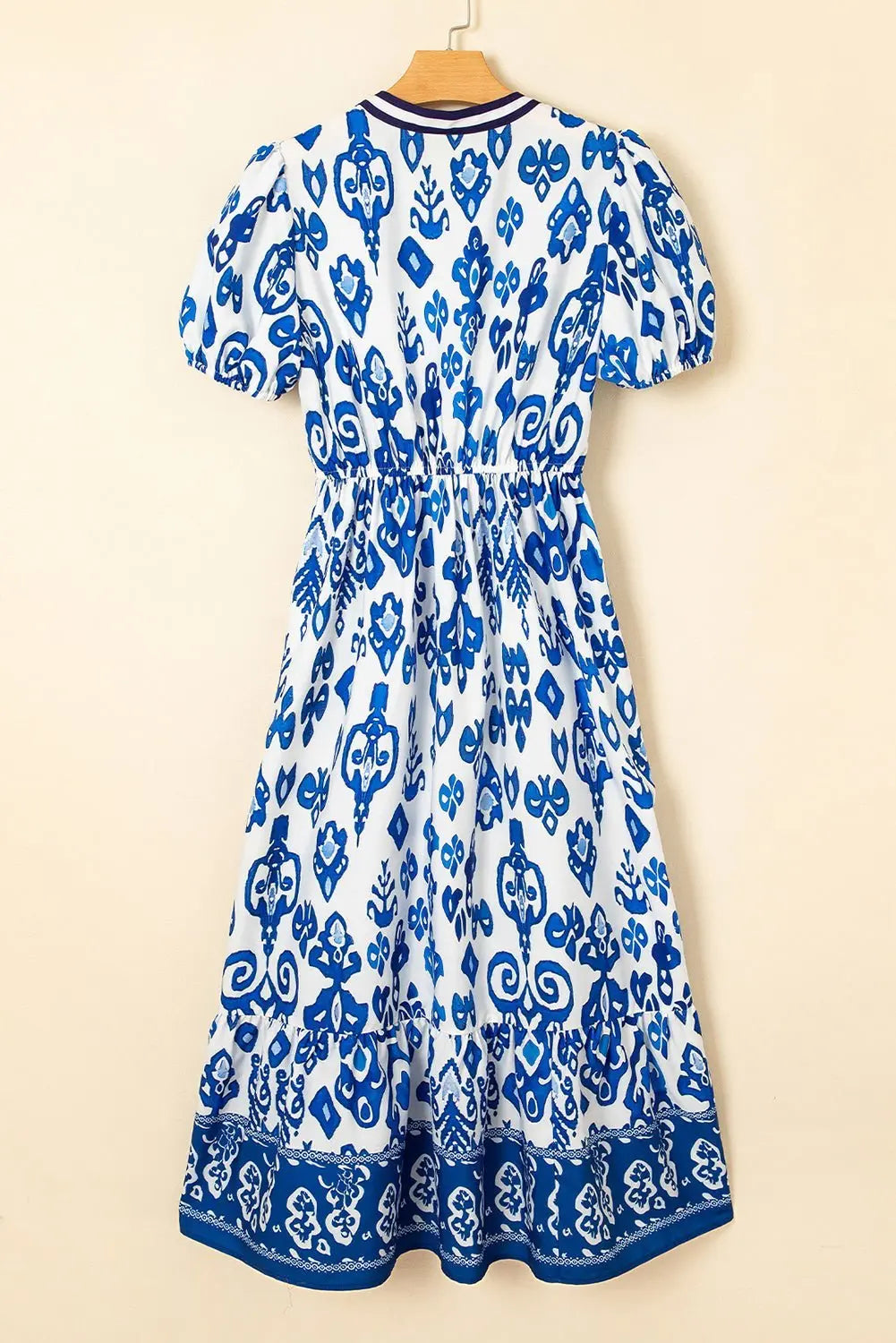 White floral midi dress with ruffle hem and colorful neckline by Emma & Rose Cape Town, featuring a feminine, flowy design.
