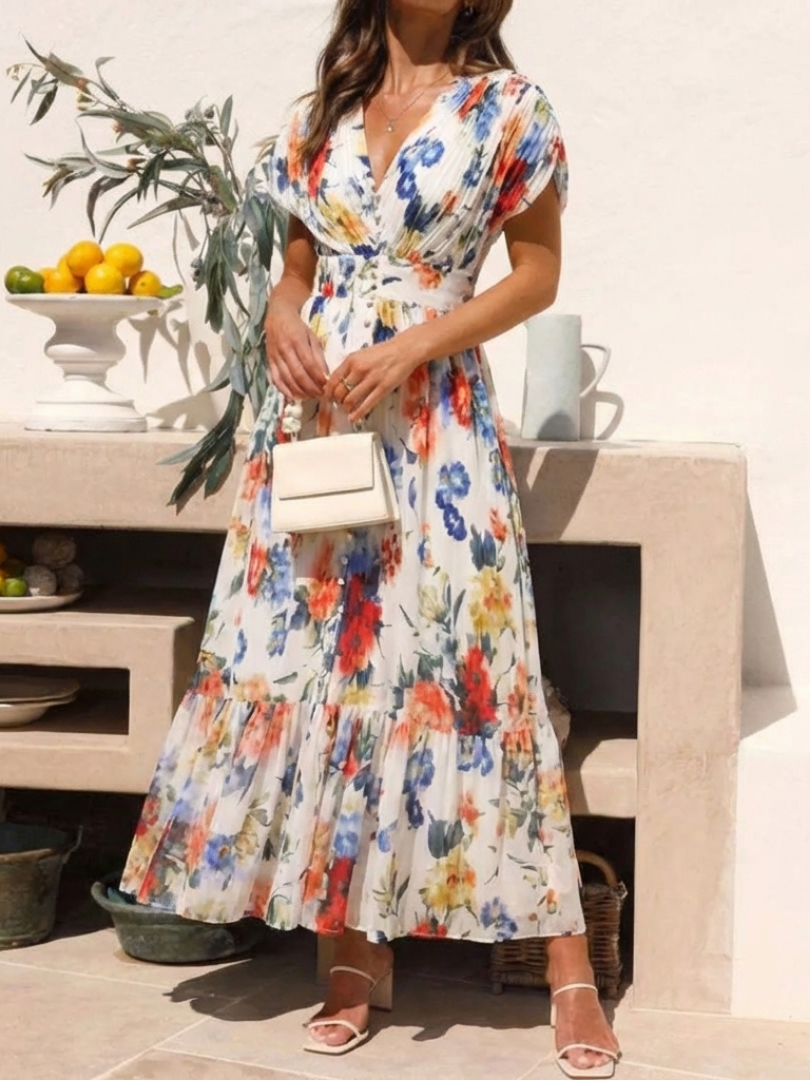Emma & Rose Cape Town Savannah pleated floral midi dress with multicolor pattern and flowy fabric, displayed on a hanger.