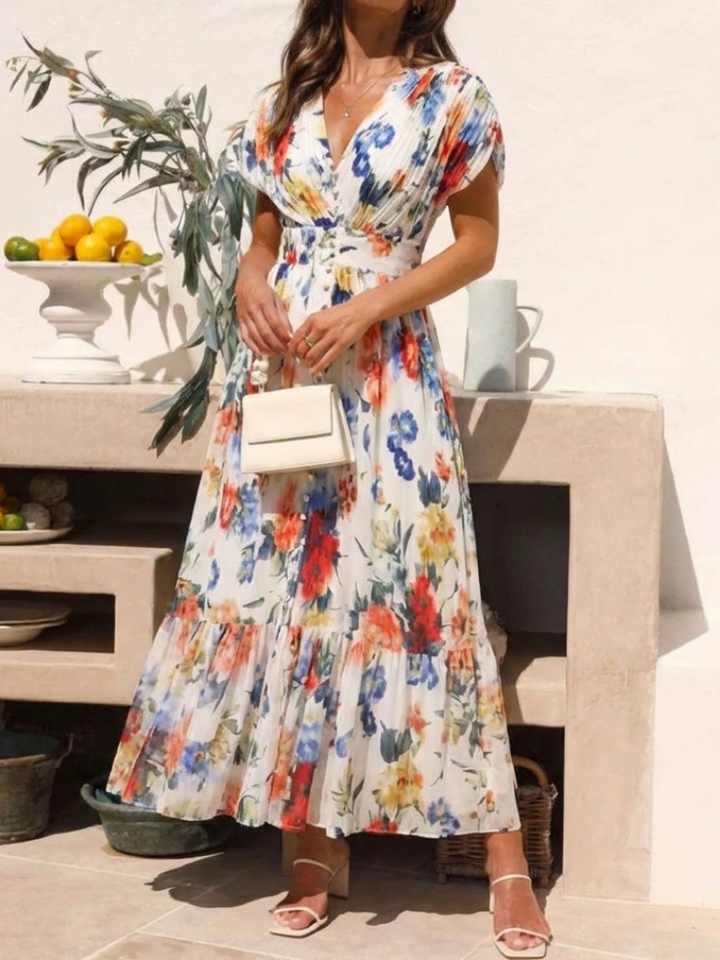 Emma & Rose Cape Town Savannah pleated floral midi dress with multicolor pattern and flowy fabric, displayed on a hanger.