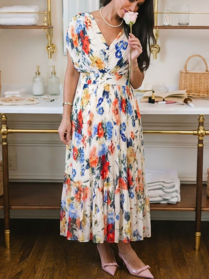 Multicolor Savannah™ pleated floral midi dress by Emma & Rose Cape Town, featuring a flowing silhouette and vibrant floral pattern.