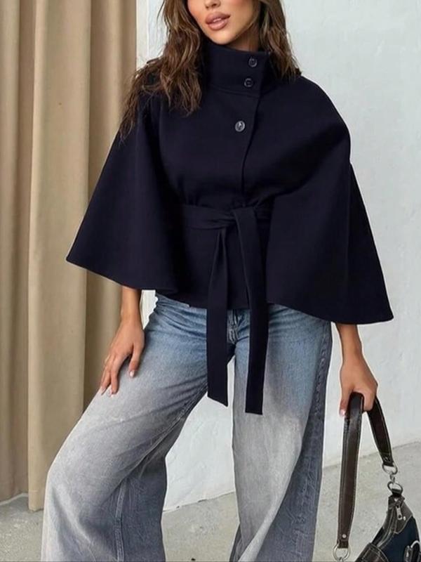 Navy blue Rosemary™ belted cape coat by Emma & Rose Cape Town, made of soft luxurious fabrics, shown hanging on a mannequin.