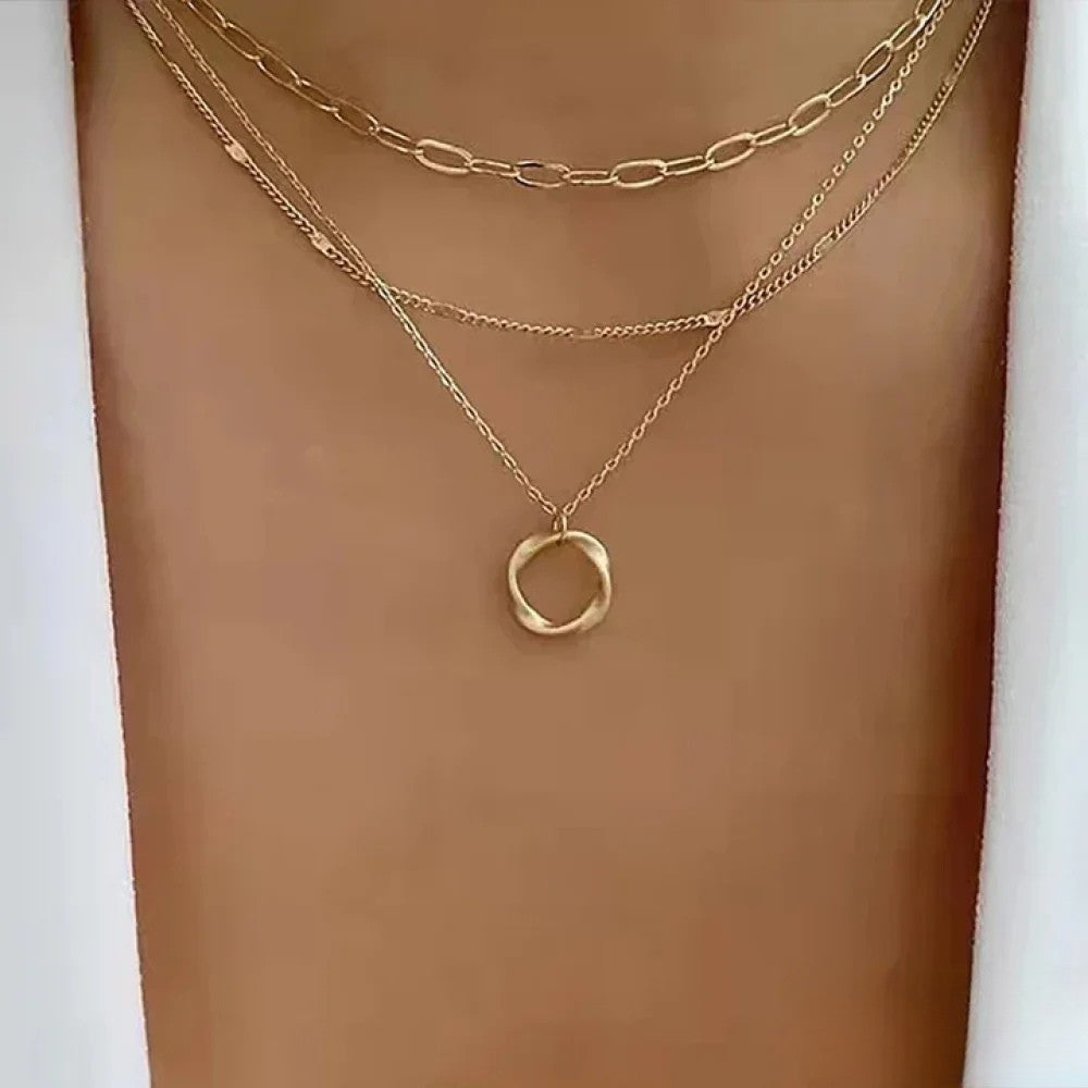 Gold layered necklace from Emma & Rose Cape Town with retro style, featuring multiple delicate chains and pendant details.