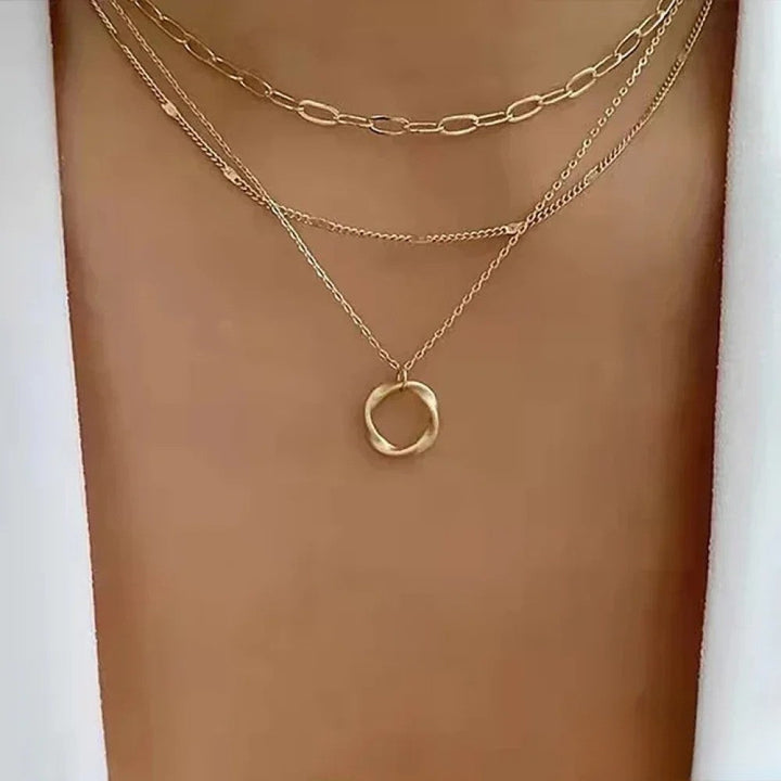 Gold layered necklace from Emma & Rose Cape Town with retro style, featuring multiple delicate chains and pendant details.