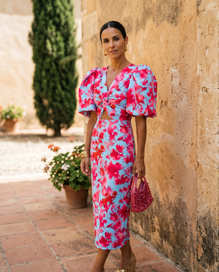 Orange printed Carla midi dress with puff sleeves from Emma & Rose Cape Town, shown on a model.