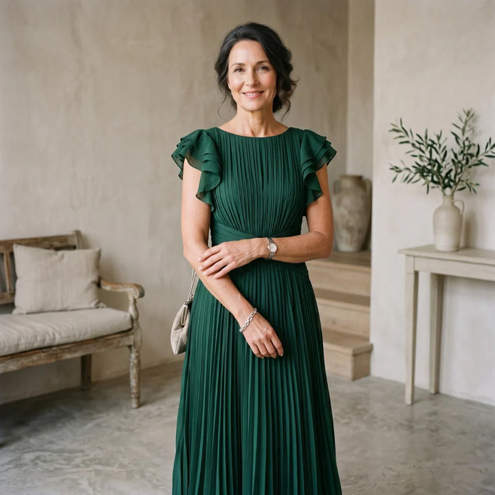 Elegant Abigail™ pleated dress by Emma & Rose Cape Town, featuring flowing fabric and a sophisticated silhouette.
