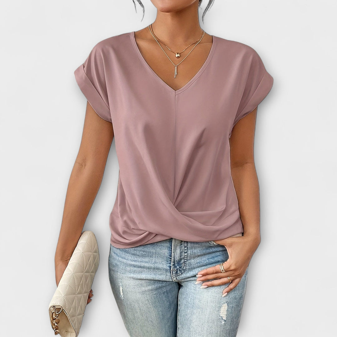 Pink Carlinda™ Elegant V-neck Top by Emma & Rose Cape Town, featuring a stylish V-neck and soft fabric, displayed on a hanger.