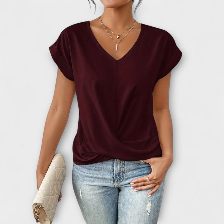 Pink Carlinda™ elegant V-neck top by Emma & Rose Cape Town, shown on a model, highlighting its stylish fit and soft fabric.