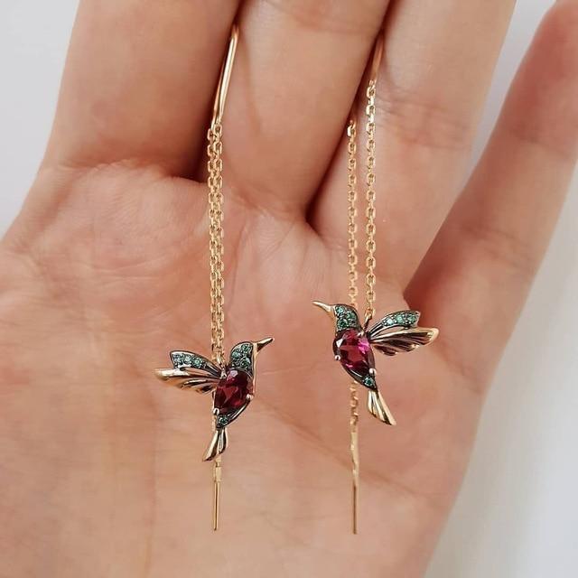 Red hummingbird enamel earrings with zirconia accents by Emma & Rose Cape Town, featuring detailed bird design and vibrant color.
