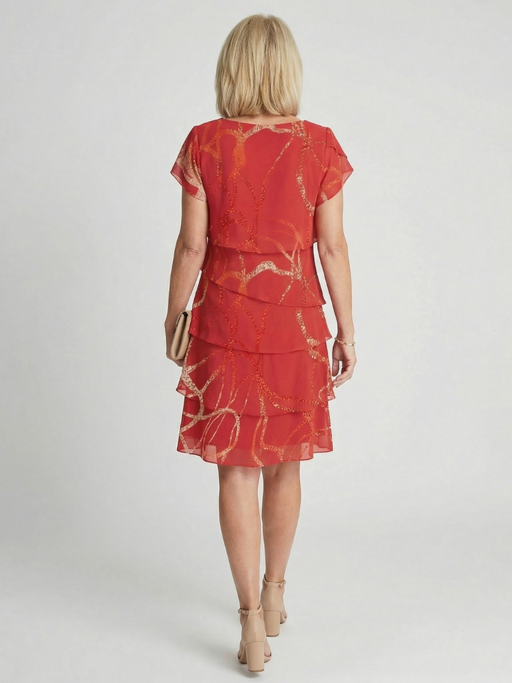 Red Nora™ abstract knee-length dress by Emma & Rose Cape Town, featuring a stylish, artistic design and fitted silhouette.