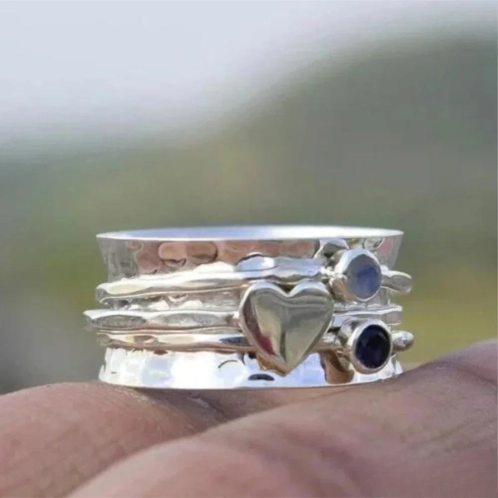 Francien™ heart-shaped spinner ring by Emma & Rose Cape Town, close-up of silver ring with detailed heart design and spinning center.