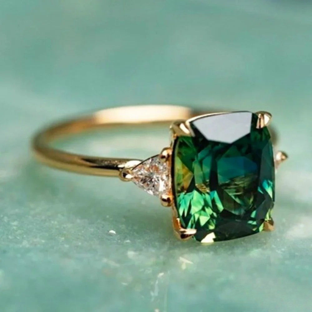 Gold™ Emma & Rose Cape Town ring with a vibrant green zirconia gemstone, showcasing an elegant gold band.