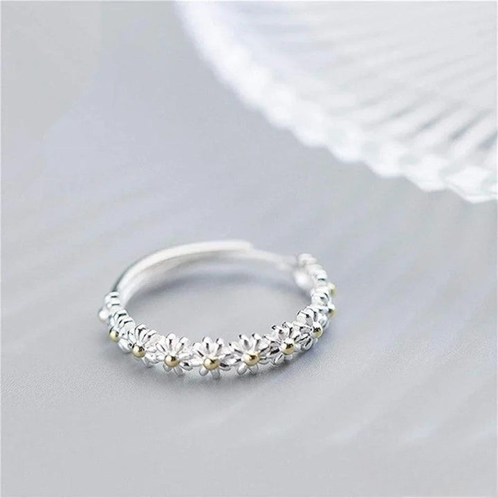 Amber™ adjustable silver ring with daisy design by Emma & Rose Cape Town, featuring a delicate floral motif and fine craftsmanship.