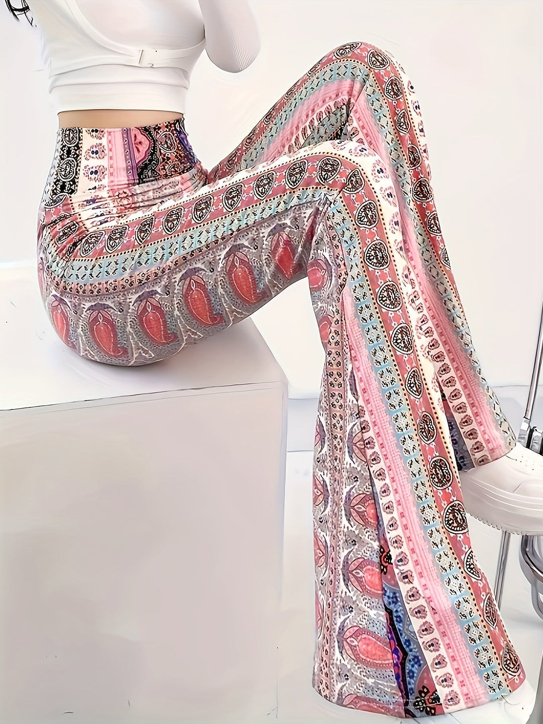 Emma & Rose Cape Town Elin™ high-waisted patterned flared trousers laid flat showing the vibrant, geometric print and wide-leg design.