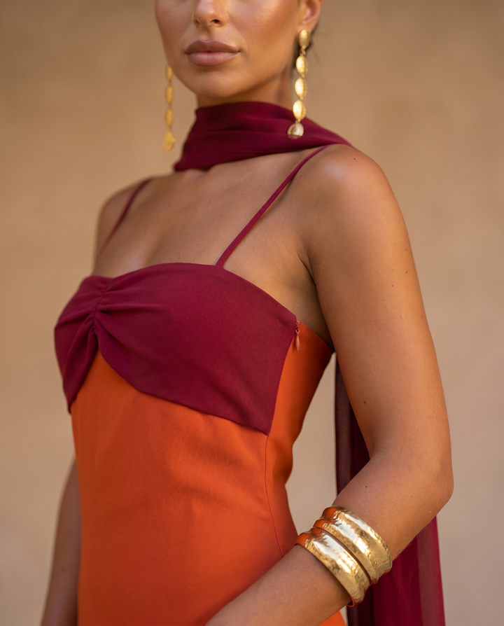 Emma & Rose Cape Town Zahara dress in vibrant orange with a red neckline, stylish and elegant for warm-weather wear.