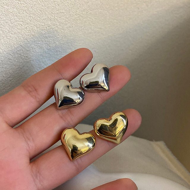Silver Rina™ elegant heart earrings by Emma & Rose Cape Town featuring intricate heart-shaped design and polished finish.
