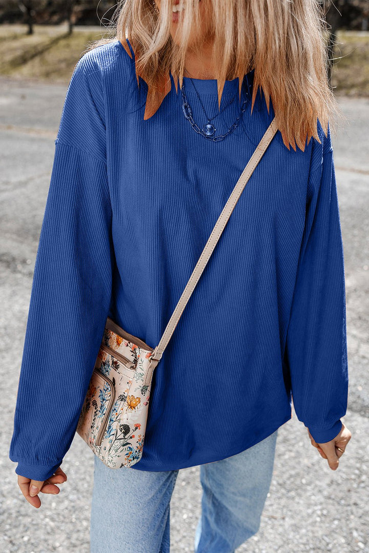 Apricot drop shoulder rib-knit oversized sweatshirt by Emma & Rose Cape Town, featuring relaxed fit and cozy knit fabric.