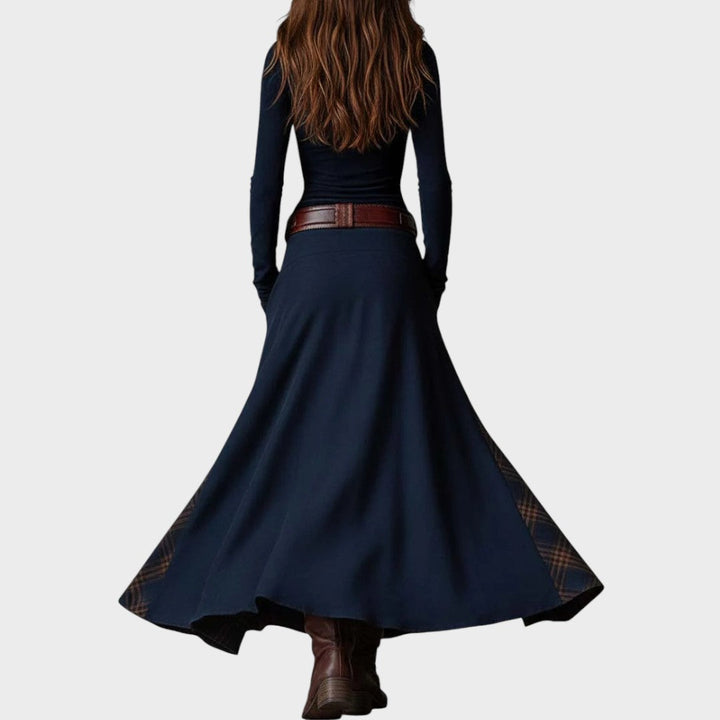 Dark blue Ivana Extravagant Dress by Emma & Rose Cape Town, showing elegant sleeveless design and flowing fabric.