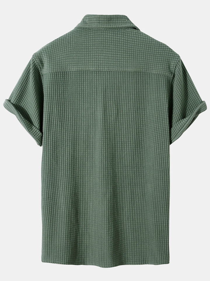 Green Tucker™ short-sleeved two-piece outfit by Emma & Rose Manhattan, featuring a comfortable top and matching shorts.