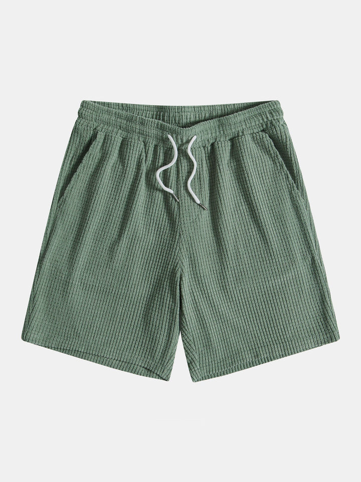 Emma & Rose Manhattan Tucker™ short-sleeved two-piece outfit for women, featuring a stylish green top and matching shorts.