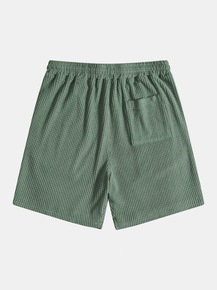 Emma & Rose Manhattan Tucker™ short-sleeved two-piece outfit in green, featuring a stylish top and matching shorts for kids.