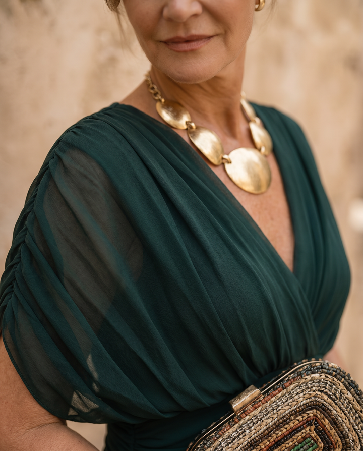Elegant maxi dress for parties by Emma & Rose Cape Town featuring a sweetheart neckline and intricate fabric details.