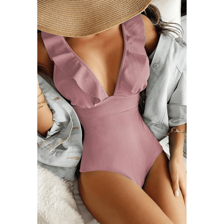 Olivia™ Mirage Swimsuit by Emma & Rose Manhattan features a gold-tone fabric with stylish cut-out details and a sleek fit.