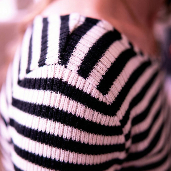 Emma & Rose Manhattan Layla™ striped slim patchwork top featuring long sleeves and a fitted silhouette with bold stripe patterns.
